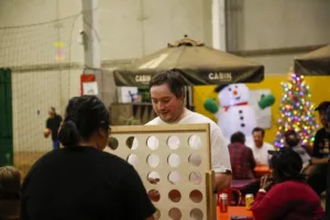Guests play a giant Connect Four game at Beach YYC holiday party.
